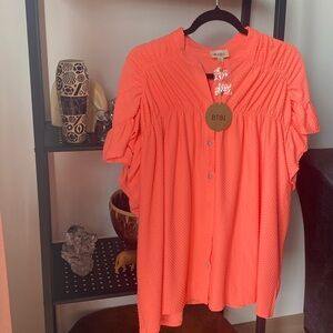 Coral Swiss dot smocked top. Size small with an oversized fit.  NWT